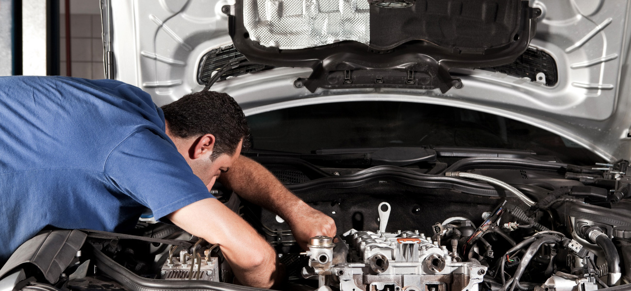 A male mechanic working on a car at our auto repair shop near Newbury Park, California.