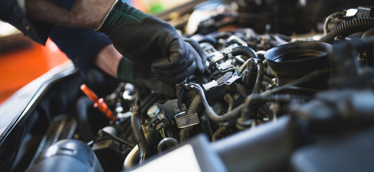 Hands working on an engine as part of our Shadow Run, Thousand Oaks auto repair services.