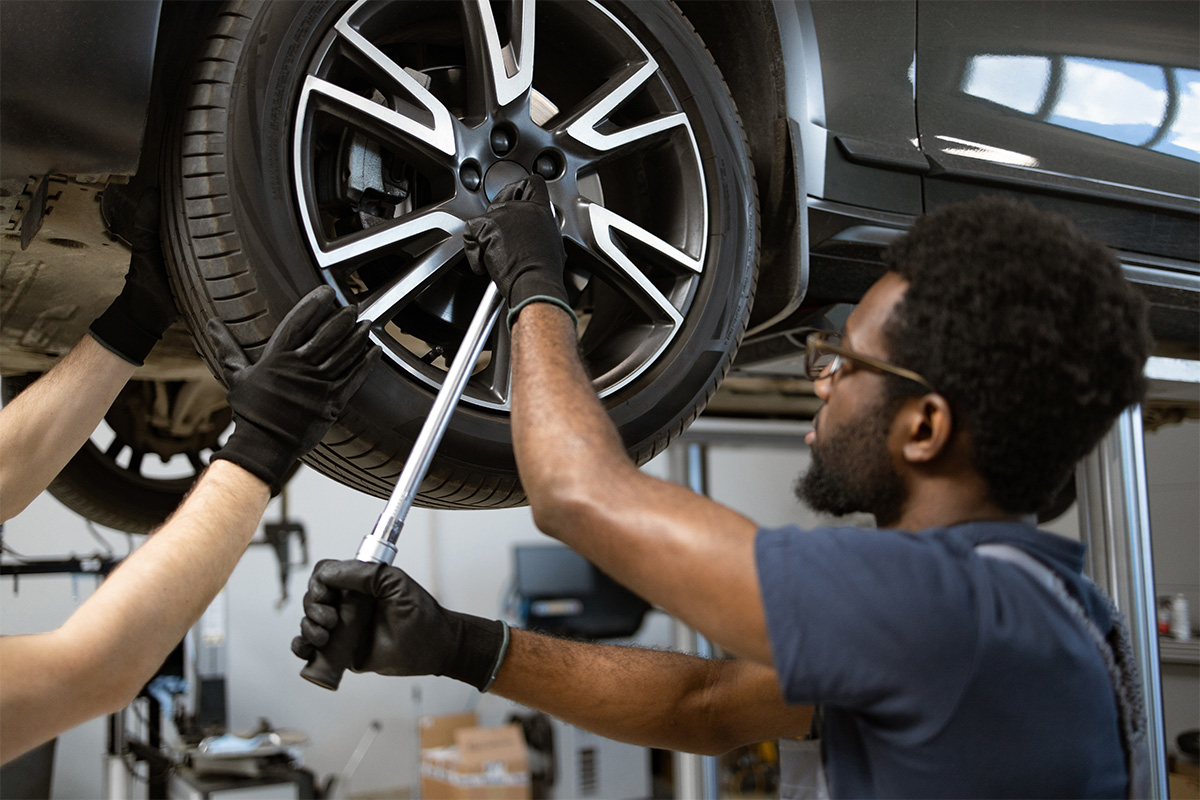 A mechanic working on a suspended tire as part of our same day auto repair near Thousand Oaks, California.